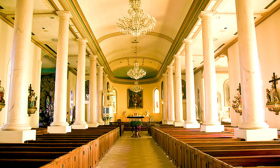 Inside view down the aisle of St. Martin de Tours Catholic Church in St. Martinville, Louisiana